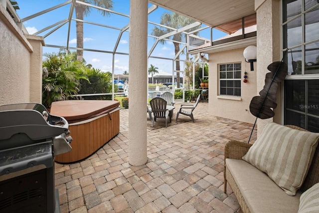 view of patio / terrace with grilling area and glass enclosure