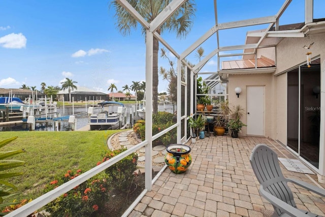 sunroom / solarium featuring a water view