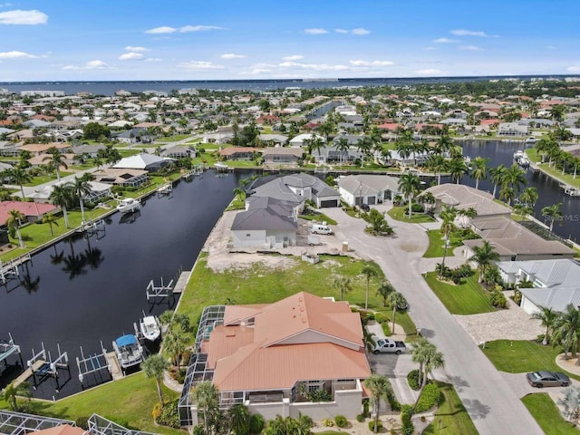 drone / aerial view featuring a water view and a residential view