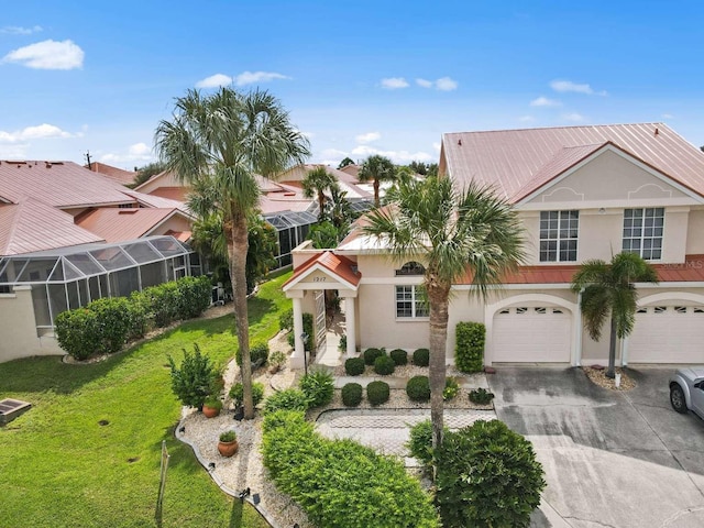 view of front of property featuring a garage and a front lawn