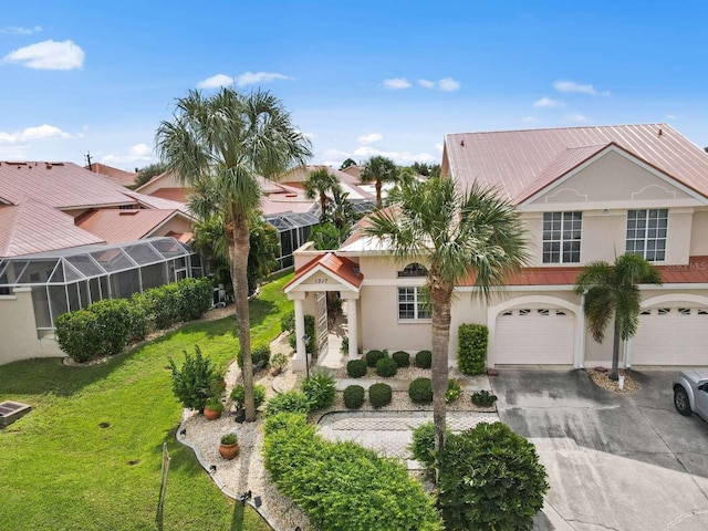 view of front of property with concrete driveway, a front lawn, and stucco siding