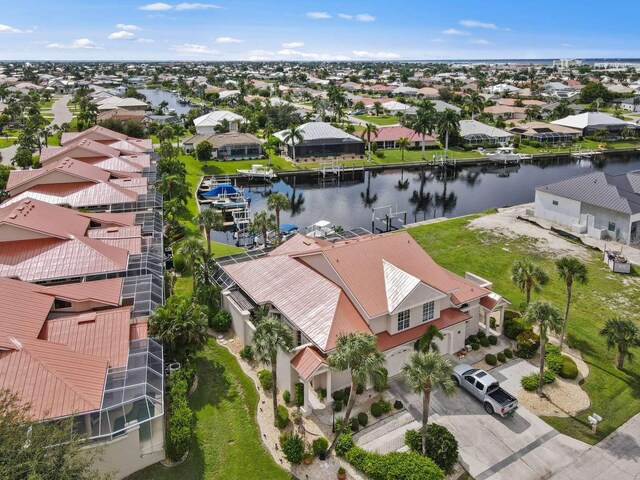 drone / aerial view featuring a residential view and a water view