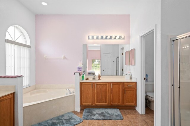 full bathroom featuring toilet, vanity, separate shower and tub, and tile patterned flooring