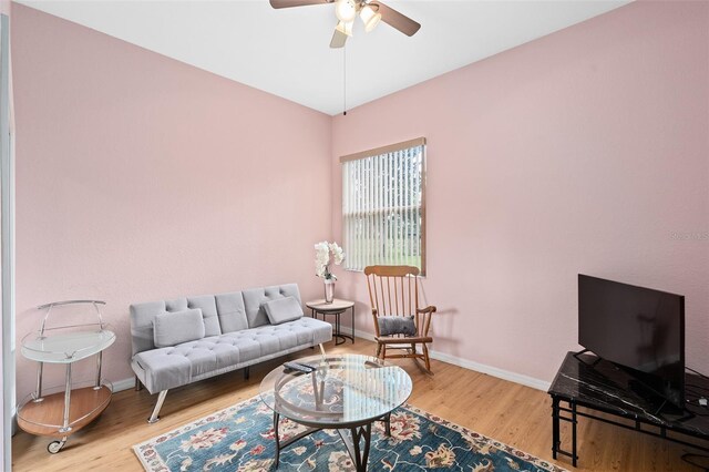 living room with hardwood / wood-style floors and ceiling fan