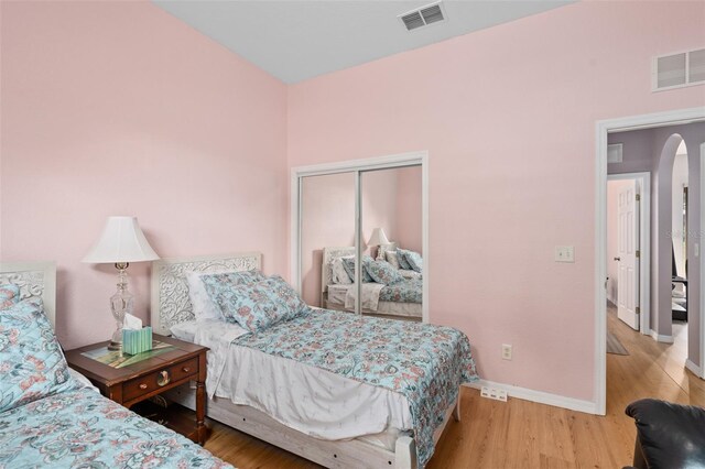 bedroom featuring hardwood / wood-style flooring and a closet