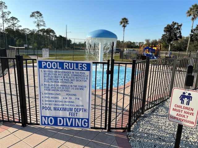 view of pool featuring a playground