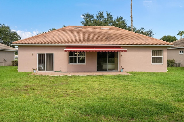 rear view of house with a lawn