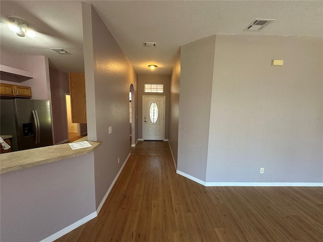 interior space with dark hardwood / wood-style floors and a textured ceiling