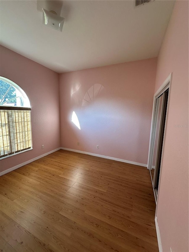 unfurnished room with hardwood / wood-style floors