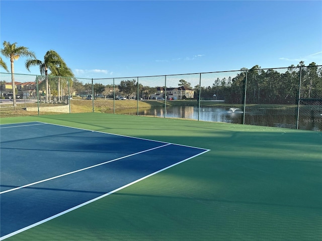 view of sport court with a water view and basketball court