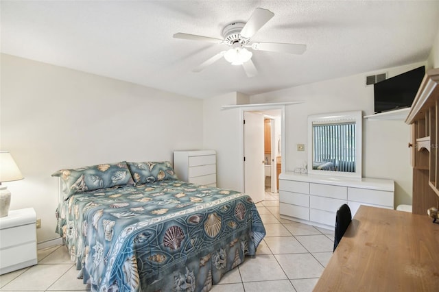 bedroom featuring ceiling fan, a textured ceiling, and light tile patterned flooring