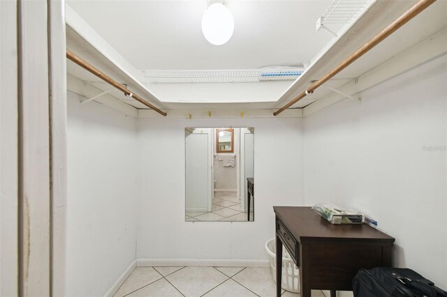 spacious closet with light tile patterned floors