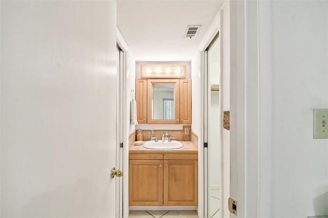 bathroom with tile patterned floors and vanity