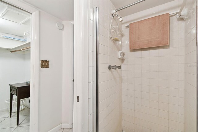 full bathroom featuring a stall shower and baseboards
