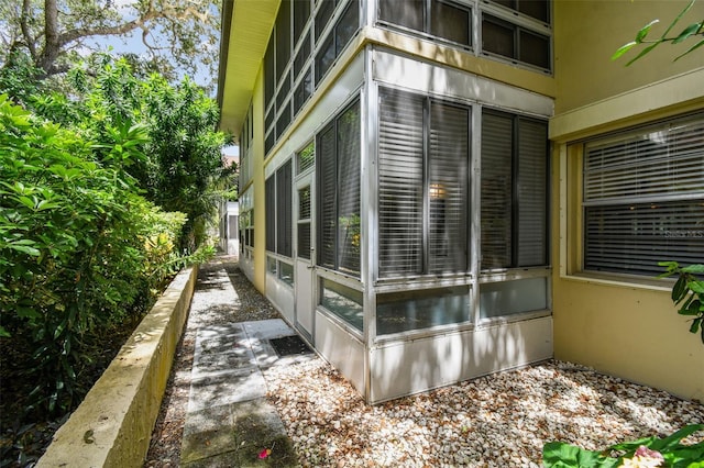 view of home's exterior with a sunroom