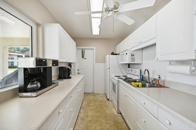 kitchen with white cabinets, white appliances, sink, and ceiling fan