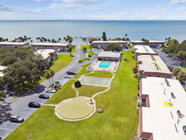 bird's eye view of a pool area and a nearby body of water