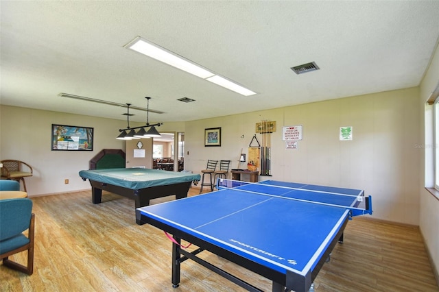 recreation room with a textured ceiling, billiards, and wood-type flooring