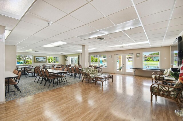 dining area featuring wood finished floors and a paneled ceiling