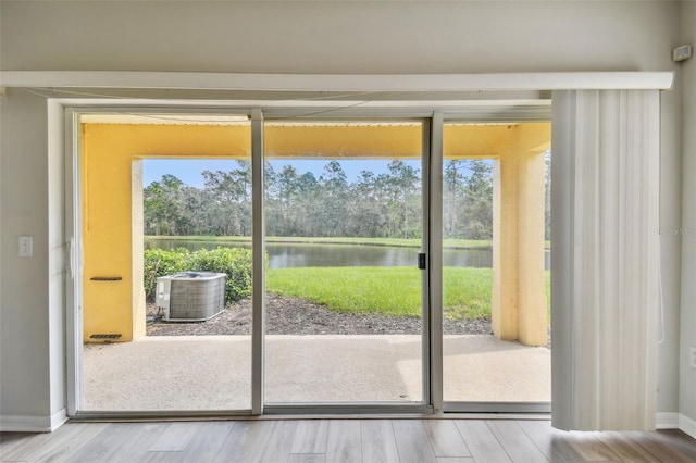 entryway featuring wood-type flooring and a water view