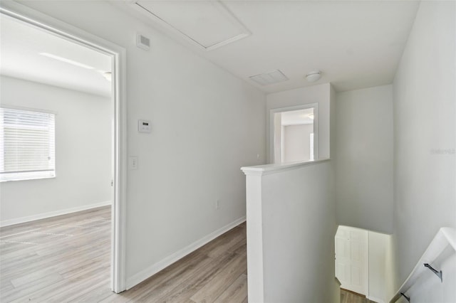 hallway with light hardwood / wood-style flooring