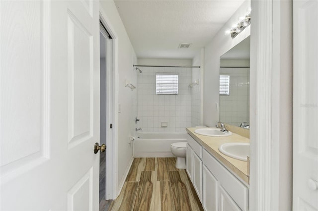 20461 Berrywood Ln, Tampa, FL 33647 - bathroom featuring visible vents, a sink, wood finished floors, and double vanity