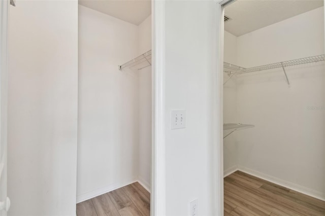 spacious closet featuring light hardwood / wood-style floors