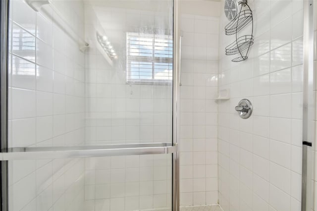 bathroom with a shower with shower door