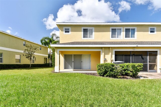 20461 Berrywood Ln, Tampa, FL 33647 - rear view of property with a yard, roof with shingles, and stucco siding