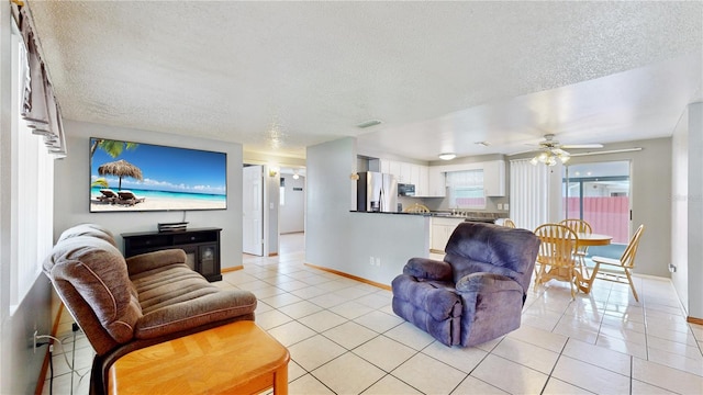 tiled living room with a textured ceiling and ceiling fan