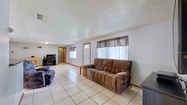 living room with light tile patterned floors and a textured ceiling