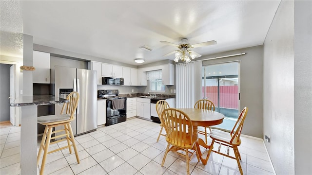 kitchen with black appliances, sink, kitchen peninsula, ceiling fan, and white cabinetry