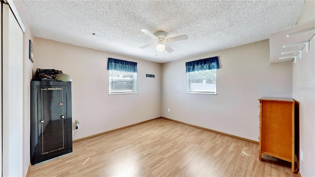 unfurnished bedroom with ceiling fan, light hardwood / wood-style floors, and a textured ceiling