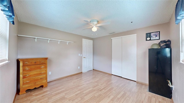 bedroom with multiple windows, ceiling fan, and light hardwood / wood-style flooring