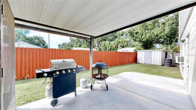 view of patio / terrace with area for grilling and a storage shed