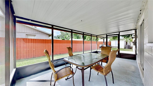 sunroom featuring vaulted ceiling