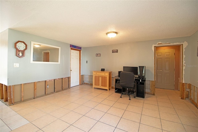 home office with light tile patterned floors and a textured ceiling