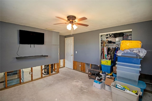 interior space with concrete floors, a closet, and ceiling fan