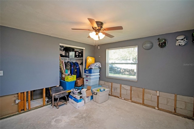 interior space with ceiling fan, concrete floors, and a closet