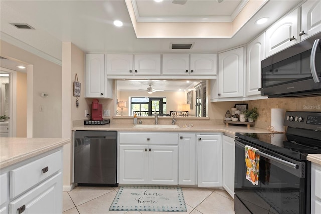 kitchen with appliances with stainless steel finishes, sink, white cabinetry, and ceiling fan