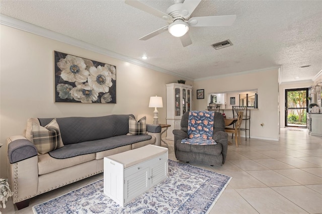 living room featuring a textured ceiling, ceiling fan, and ornamental molding