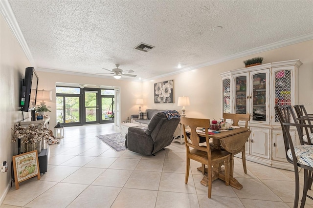 dining space featuring crown molding, a textured ceiling, light tile patterned flooring, and ceiling fan