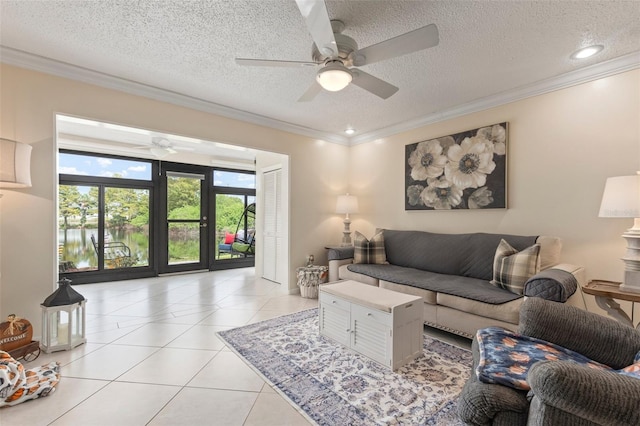 tiled living room featuring ornamental molding, a textured ceiling, and ceiling fan