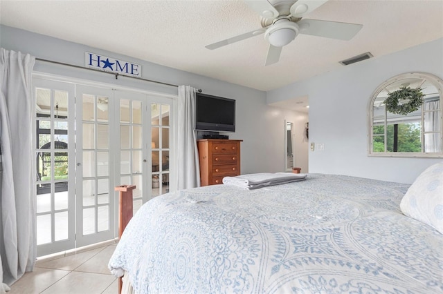 bedroom featuring multiple windows, ceiling fan, light tile patterned floors, and french doors