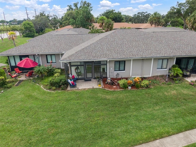 rear view of property with a yard