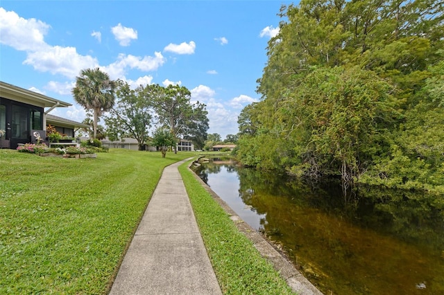 exterior space featuring a yard and a water view