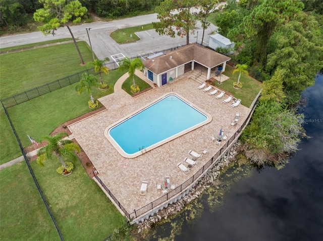 view of swimming pool featuring a water view and a patio area