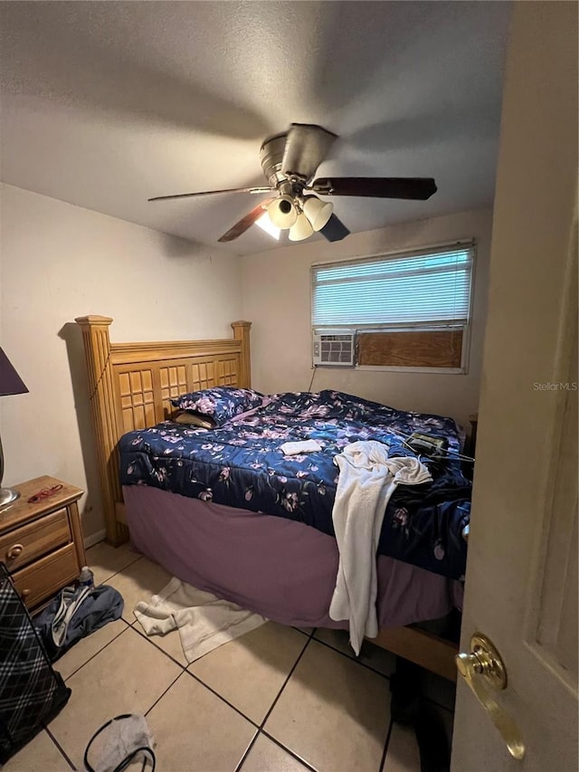 tiled bedroom featuring ceiling fan