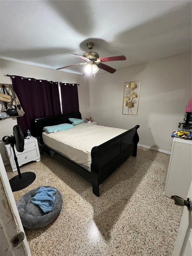 bedroom with ceiling fan and a textured ceiling