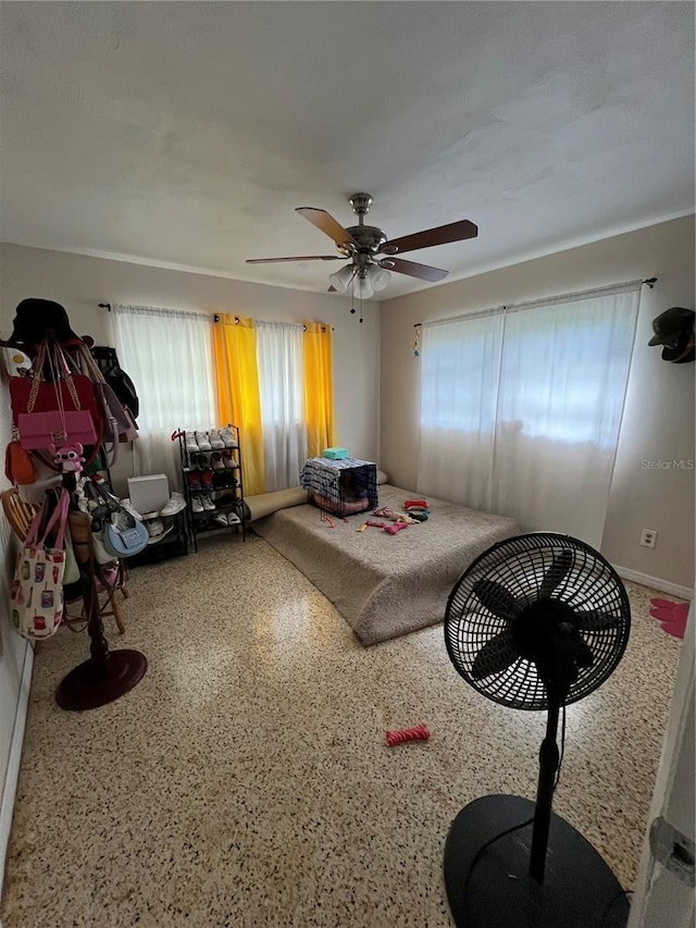 interior space with ceiling fan